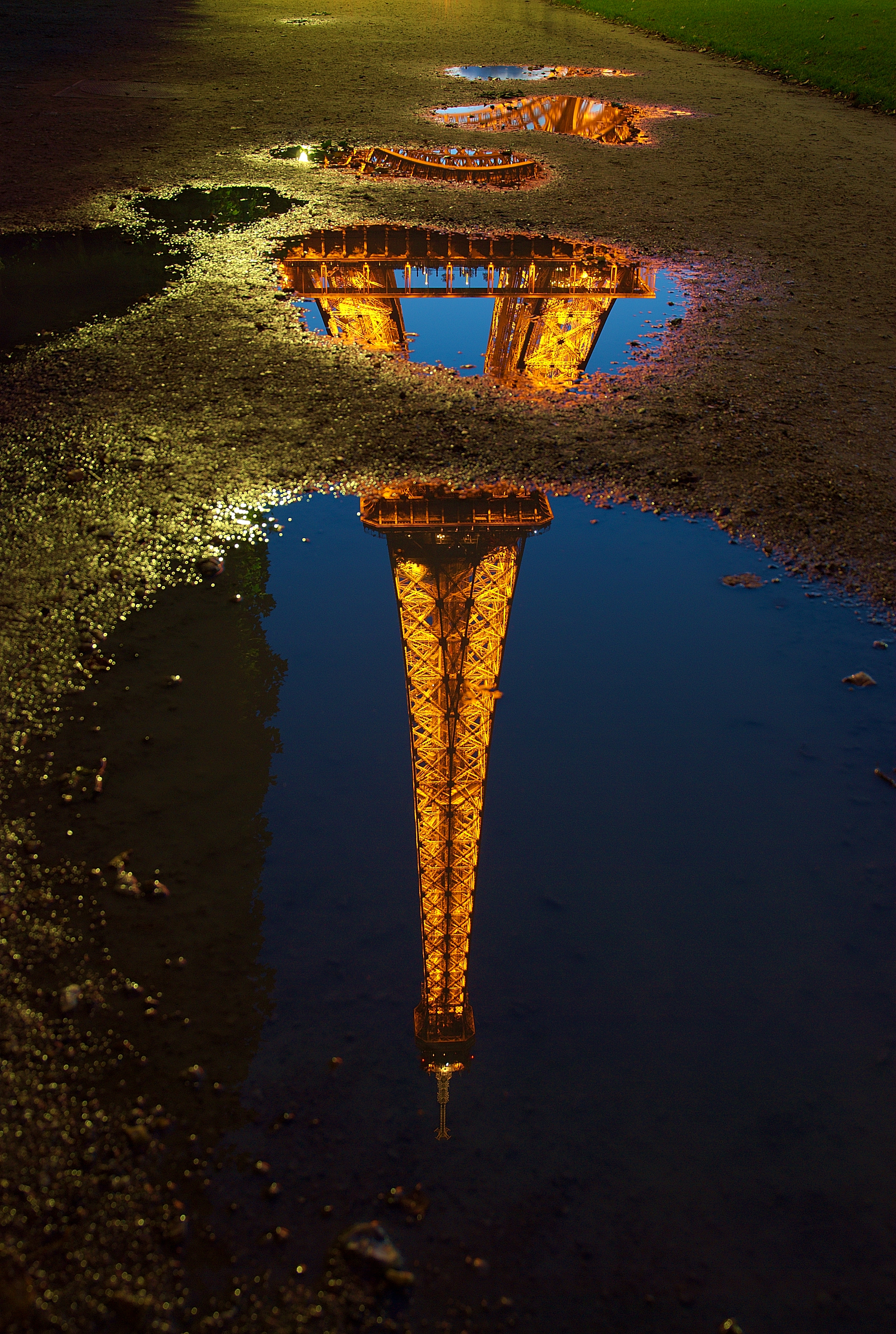 Paris skyline at night with reflections on the water